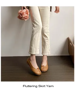 Top view of camel tabi ballet flats with leather texture and delicate bow detailing