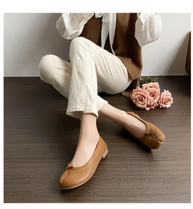 Top view of brown matte leather Tabi flats with delicate bow and split-toe design