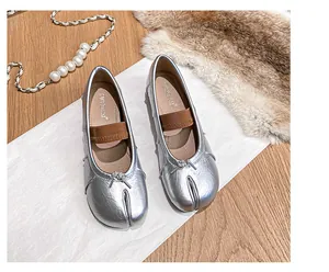 Detailed top view of silver Tabi split-toe flat shoes with metallic finish and bow