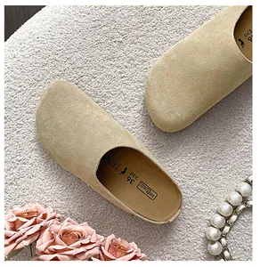 Close-up of beige suede mule slippers with soft footbed detail and size marking
