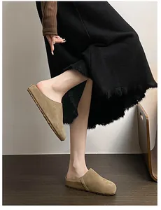 Detail of khaki suede mule slippers featuring thick cork-style flat soles for women