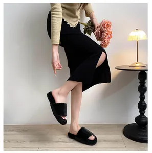 Cozy black faux fur slide slippers on a thick platform sole in a stylish home setting