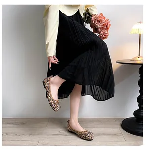 Detail view of leopard print ballet flats with delicate bow and square toe on model