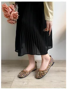 Close-up of leopard print ballet flats with delicate bow detail and soft square toe