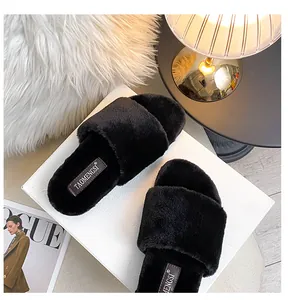 Luxurious black faux fur open toe slide slipper with soft plush texture on white box
