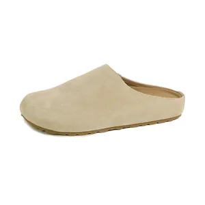 Beige cowhide leather mule clogs with cork midsole and non-slip sole in side view