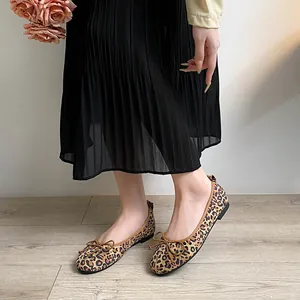 Elegant square toe leopard print flat shoes with bow knot detail on model feet