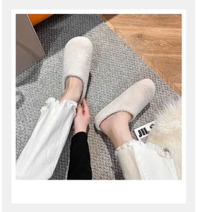 Detailed view of cream plush mule slippers with soft faux shearling texture for winter