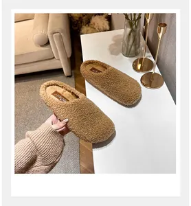 Close-up of fuzzy brown teddy fleece mules featuring warm plush lining and stylish backless design