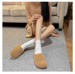 Cozy camel faux fur slippers shown in a comfortable home setting for autumn wear