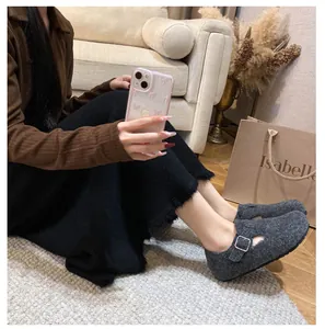 Detail view of gray wool felt clog slipper with adjustable silver metal buckle on side