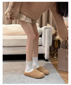 Close-up of warm brown faux shearling mules for women featuring plush cozy texture