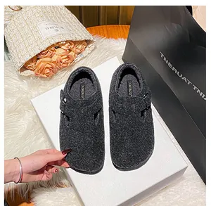 Top view of dark grey felt Boston-style clogs with metal buckle on a white background