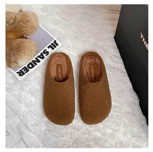Detailed top view of brown faux fur mules with warm plush lining and stylish round toe