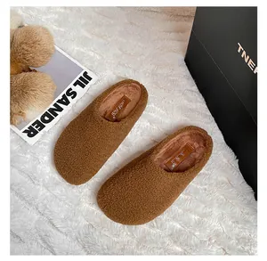Macro shot of dark brown teddy fleece mule slippers with soft warm textured lining