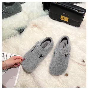 Detail shot of grey felt platform clogs with buckle strap and plush interior