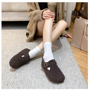 Detail of warm brown felt clogs with adjustable buckle strap and round toe design