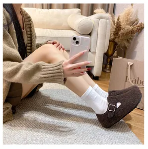 Close-up of brown felt warm clog shoes with adjustable metal buckle and soft fleece lining