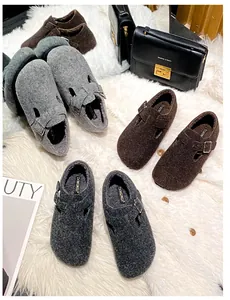 Detailed view of cozy felt slip-on clogs with adjustable buckles and warm plush lining