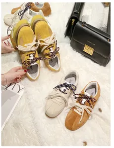 Retro suede leisure trainers in yellow, beige and caramel colors on a plush background