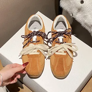 Retro brown suede sneakers with double laces and vintage athletic design for women