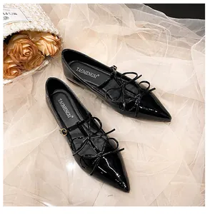 Top view of black pointed-toe Mary Jane flats with three delicate bows and buckle detail