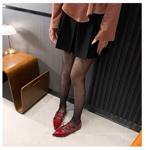 Close-up of red patent leather Mary Jane flats with bow detail and three thin straps