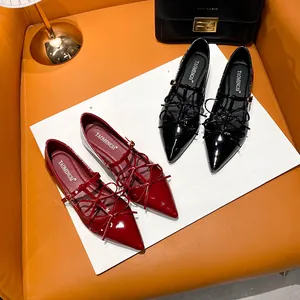 Classic pointed toe Mary Jane flats in red and black patent leather with bow details