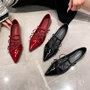Elegant pointed-toe Mary Jane flats with bow details in red and black patent leather
