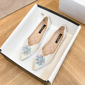Elegant pointed-toe flat shoes in cream white featuring large 3D crystal flower decor