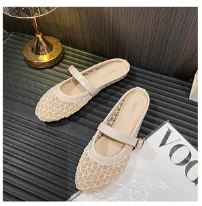 Detail of beige mesh Mary Jane flats with woven hollow-out texture and buckle strap