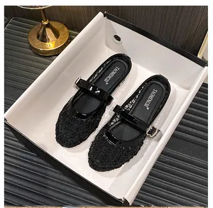 Detail of black mesh Mary Jane flats featuring hexagonal breathable netting and patent leather