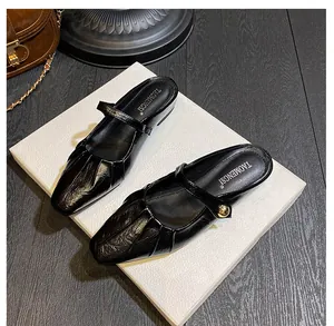 Detailed close-up of a black square-toe Mary Jane mule with pleated leather texture