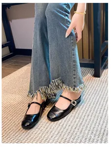 On-foot view of black Mary Jane mules with adjustable buckle straps and a round toe