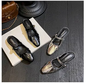 Detail of square toe pleated Mary Jane mules in metallic silver and classic black