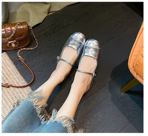 Silver mirror Mary Jane mule with buckle detail and 35mm platform on wooden floor