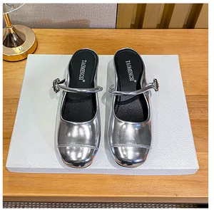 Top view of silver metallic Mary Jane mules with buckle strap and round toe design