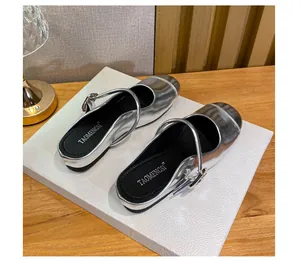 Close-up of silver metallic Mary Jane mules with shiny mirror finish and buckle detail