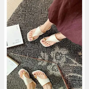 Chic beige square toe thong sandals with gold buckle and comfortable flat sole for summer