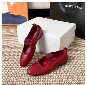 Close-up of wine red leather Mary Jane ballet flats with elastic strap and heel pull tab