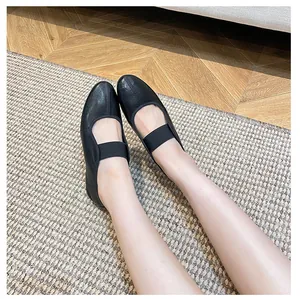 On-foot view of black matte leather Mary Jane flats with wide elastic strap detail