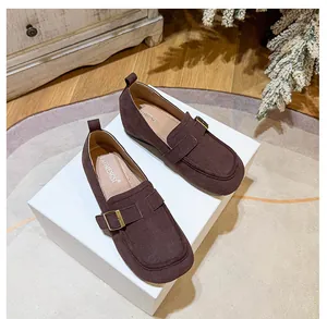 Detail of coffee brown suede loafers with vintage metal buckles and a 5cm platform sole