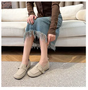 Detail shot of beige suede loafers with 5cm height boost and classic metal buckle