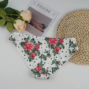 Detailed view of white lingerie briefs with red rose floral print and black polka dots