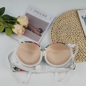 Floral bra set with red roses, thick nude padding, and adjustable straps in flat lay view