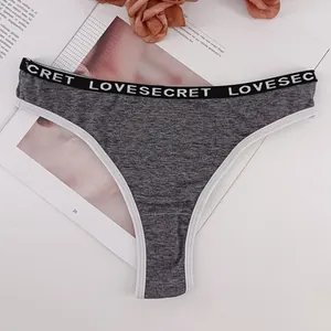 Women's grey cotton thong featuring a wide black elastic waistband with white lettering