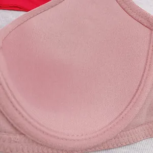 Detailed macro view of the light pink bra cup fabric and fine stitching craftsmanship