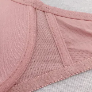 Close-up of pink bra side wings with breathable mesh and reinforced herringbone stitching