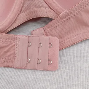 Close-up of three-row metal hook eye closure and ribbed texture fabric on women bra