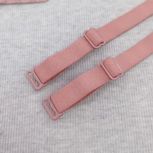 Detailed view of adjustable pink lingerie shoulder straps with matte texture and hooks